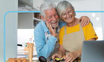 Older couple smiles while learning to cook